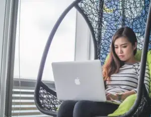 woman practicing mindfulness while working on a laptop computer