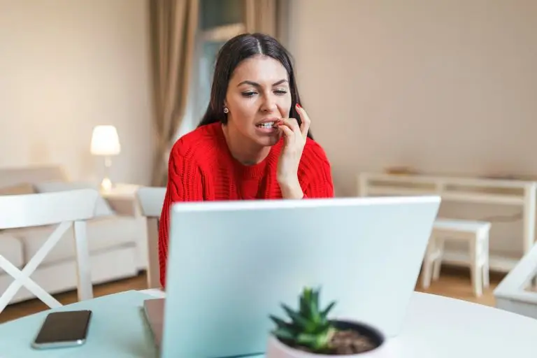 woman biting mails displaying anxiety