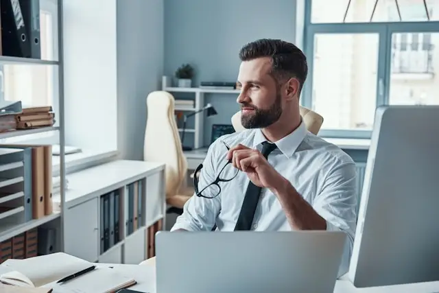 man pausing during work in an office environment